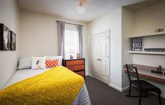 a bedroom with a bed and a desk in a 555 waverly unit