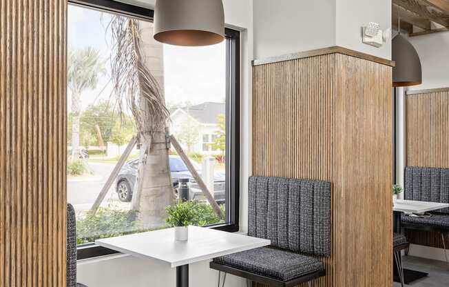 a dining area with a table and chairs and a window at The Sophia, Venice, FL, 34275