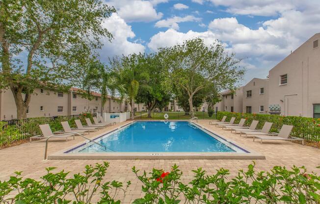 a house with a pool in front of a building