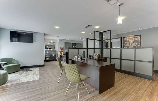 A modern office space with a reception desk and chairs.