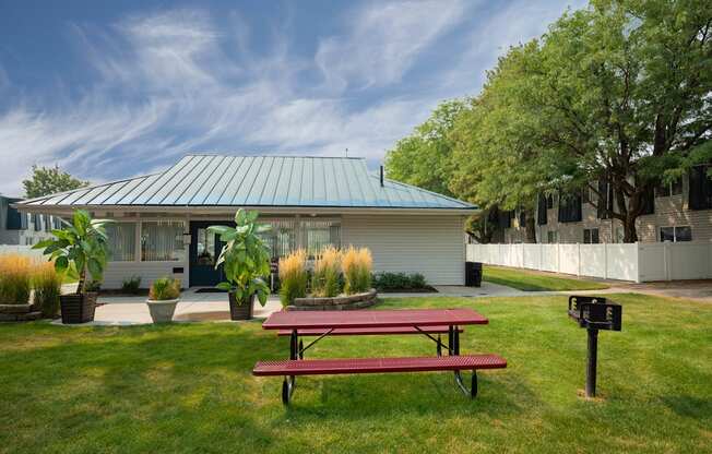 a picnic table in a yard in front of a house