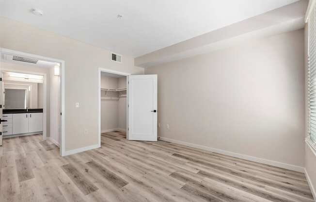 an empty living room with white walls and wood flooring