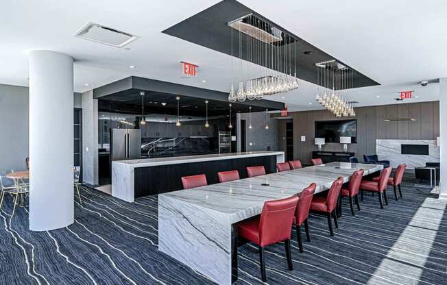 3thirty3 new rochelle ny apartment high rise photo of co-working area with large community table work station made of marble with modern furniture and finishes next to community kitchen area