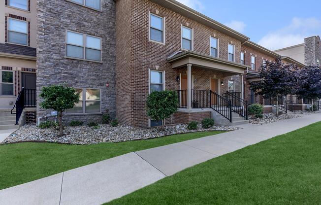 a large lawn in front of a brick building