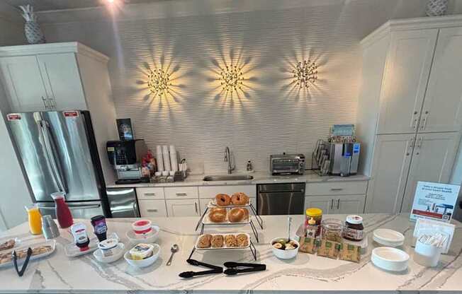 A breakfast spread is laid out on a table in a kitchen.