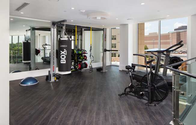 a gym with a lot of exercise equipment and a large window