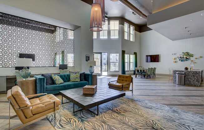 A living room with a patterned rug and a large window.