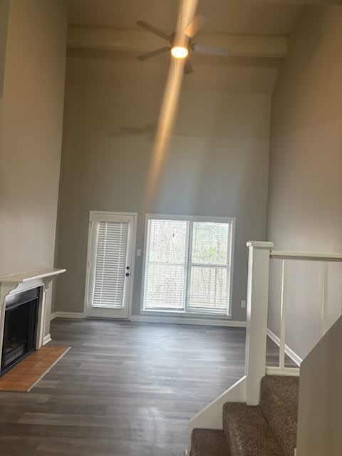 A room with a fireplace and a staircase.