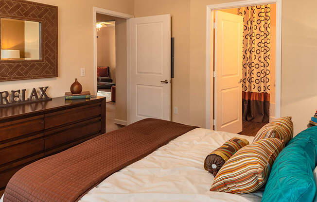 a bedroom with a bed and a dresser