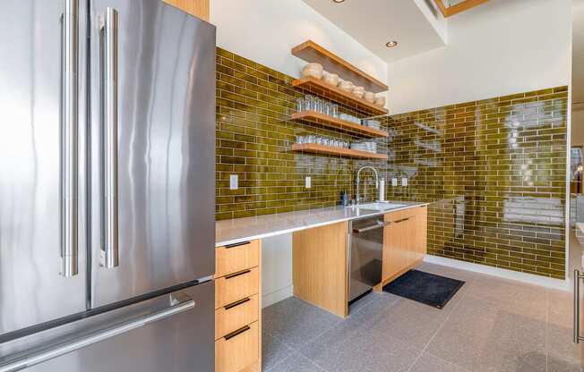 a kitchen with green tile and stainless steel appliances at Marina Square, Bremerton, WA