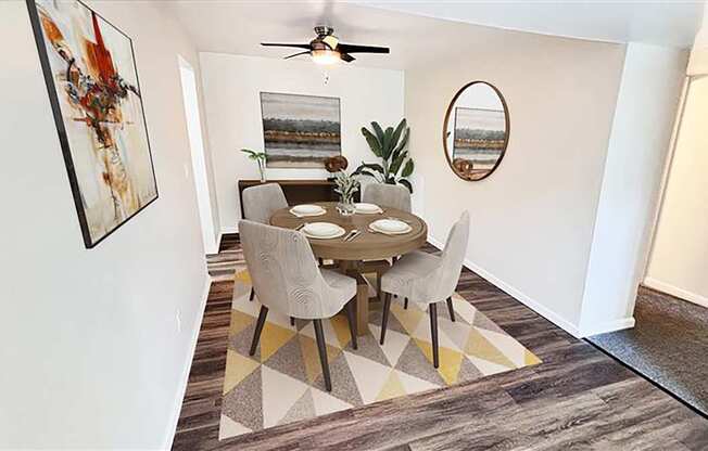 A dining room with a table and chairs.