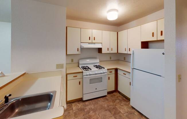 two bedroom kitchen with white appliances