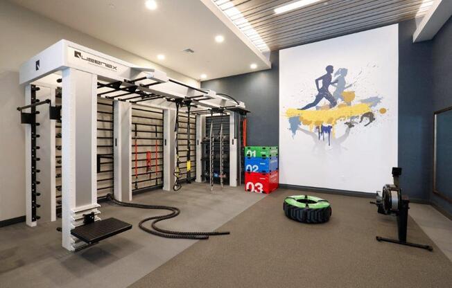 a gym with weights and a painting on the wall