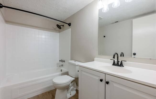 a bathroom with a sink toilet and a tub