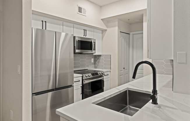 a kitchen with a sink and a refrigerator