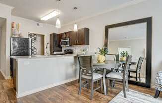 an open kitchen and dining area with a table and chairs