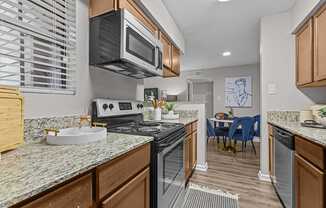 A kitchen with a stove top oven and microwave.