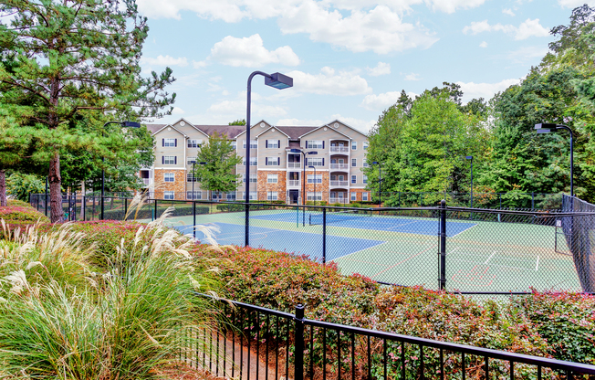 View of Tennis Court, Showing Fenced-In Area and Landscaping at Summer Park Apartments
