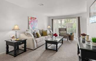 Open and airy living room with natural lighting at Knottingham Apartments in Clinton Township, MI.