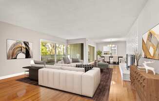 a living room filled with furniture and a large window