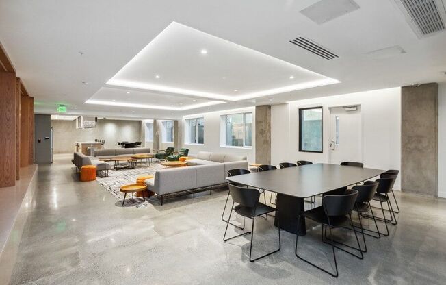 Community lounge with sofas and tables at TL Residences