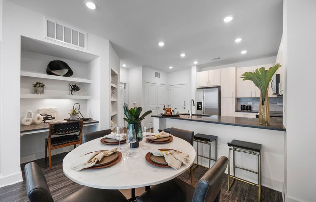 an open kitchen and dining area with a table and chairs