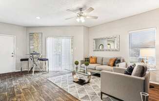 Bright and airy living room with large windows at Laurels of Sendera apartments in Arlington, TX