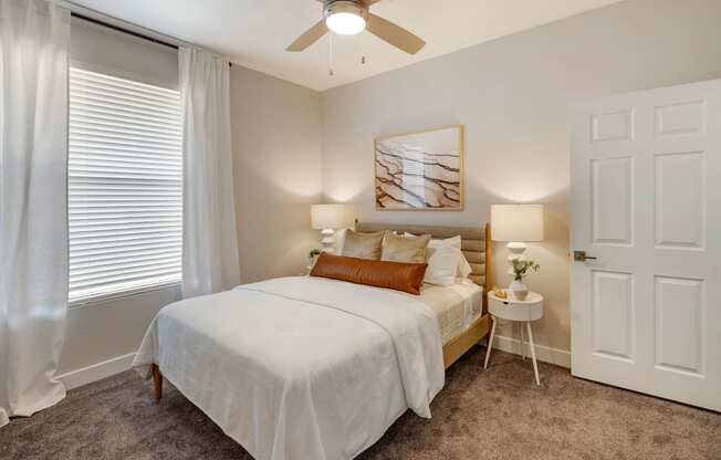 a bedroom with a bed and a ceiling fan at Paisley and Pointe Apartments, Las Vegas, NV