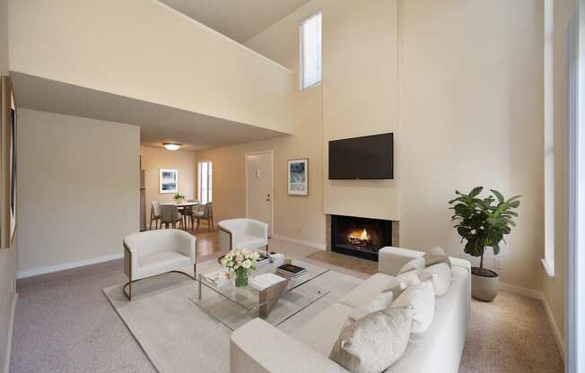 a living room with a couch and a table and a fireplace