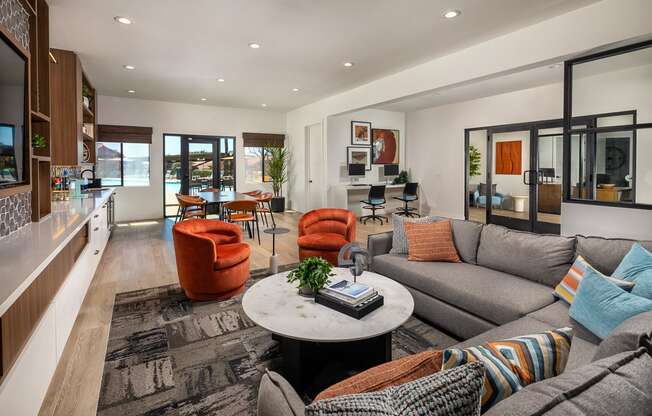 a living room with couches and chairs and a table