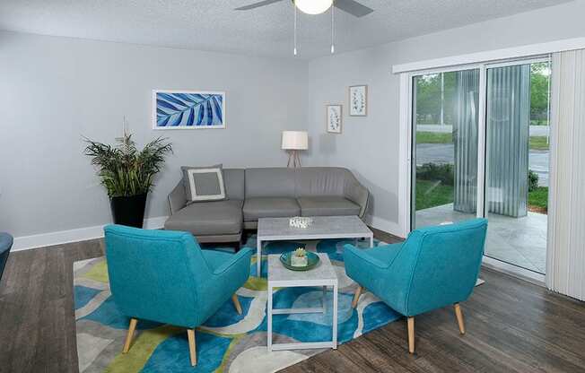 Apartments in for Rent in Jacksonville - Modern Living Room With Stylish Decor, Hardwood Flooring, and Access to Outdoor Patio