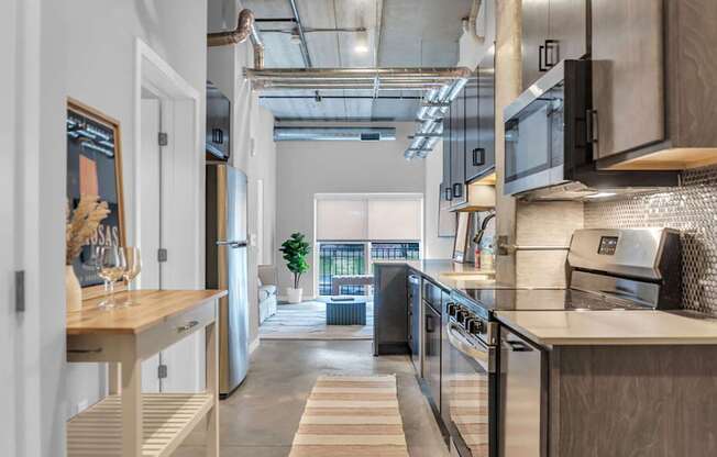 A modern kitchen with a view of the balcony outside.