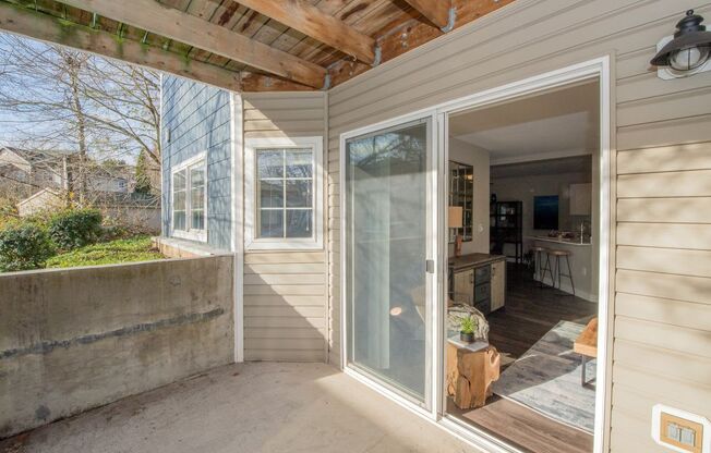 a screened in porch with a kitchen in the background at The Arden Apartments, Oregon