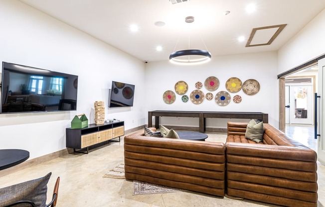 Living room with couches and a tv at The Parker Austin, Pflugerville, TX