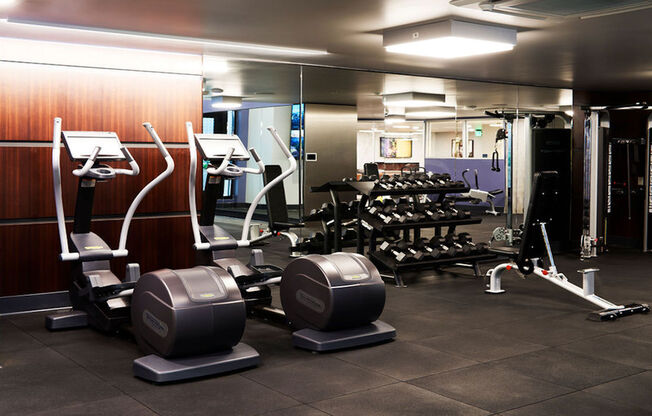 Expansive fitness center with elliptical, free weights, and weight stations