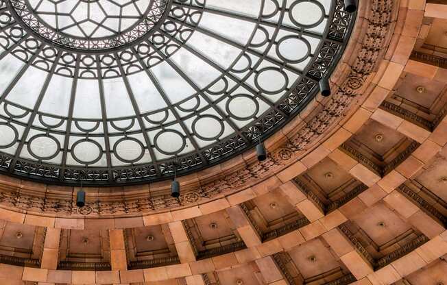 A large, ornate glass dome in the center of a building at The Pennsylvanian Apartments, Pennsylvania