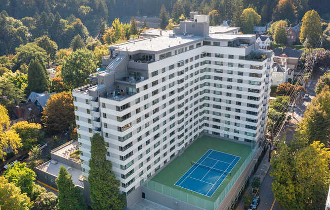 a building with a tennis court on the bottom of it