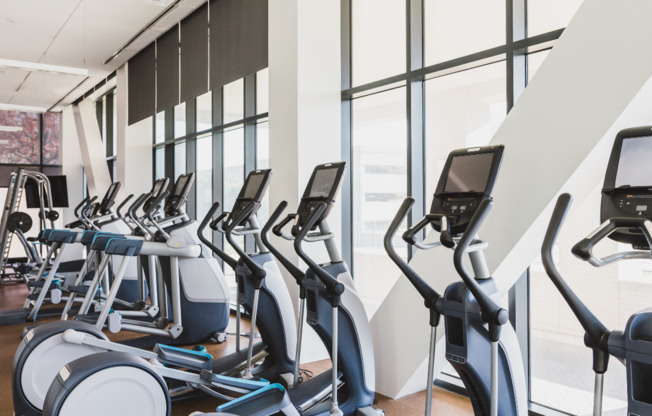 Floor to ceiling windows offer an open and airy atmosphere in our membership-style fitness center