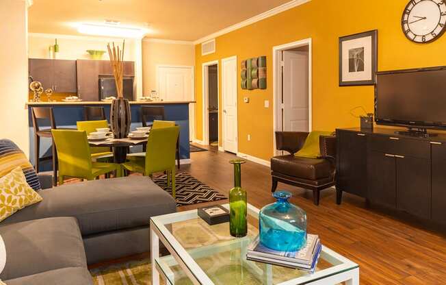 a living room with a couch and chair and a coffee table with a vase on it