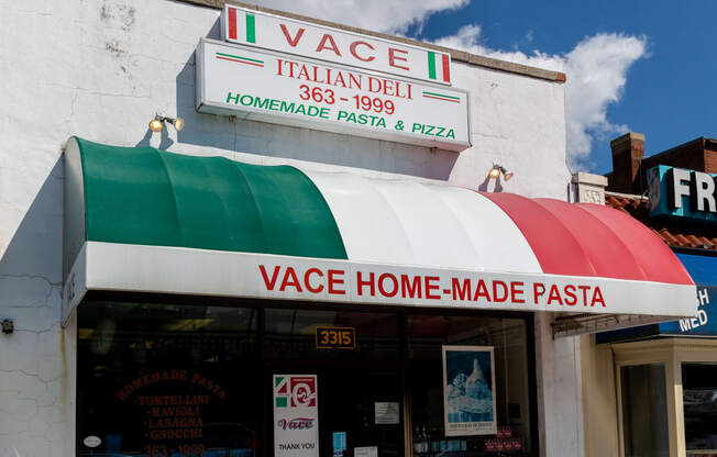 the front of a pizza restaurant with a rainbow awning