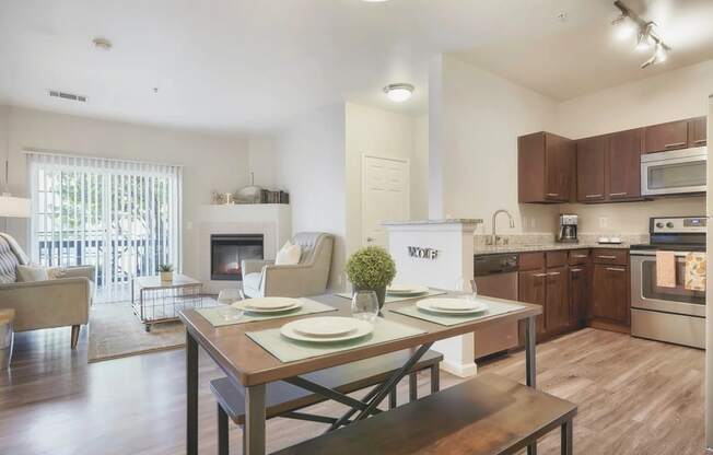 a living room with a dining room table and a kitchen