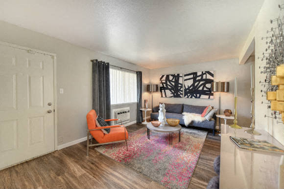 Living Room with Hardwood Inspired Floors, Orange Chairs and Window