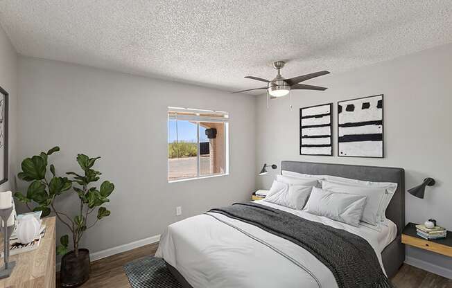 Model Bedroom with Carpet and Window View at Hilands Apartments in Tucson, AZ.