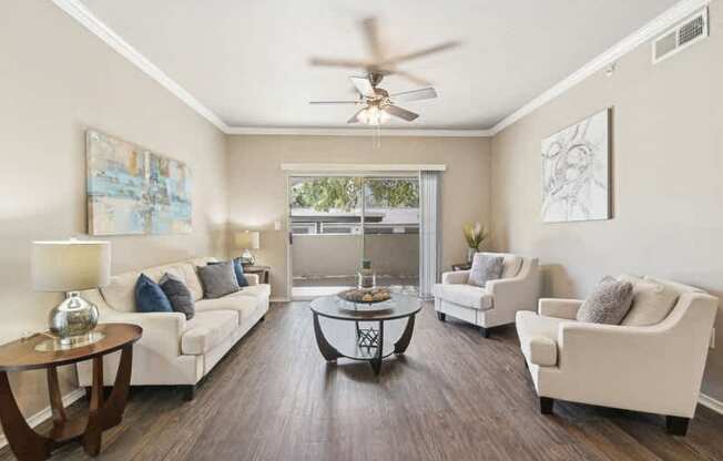 a living room with furniture and a ceiling fan