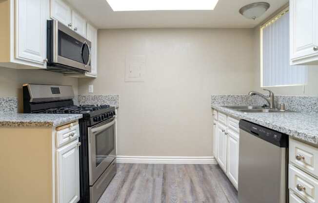 A kitchen with a black microwave above a black stove.