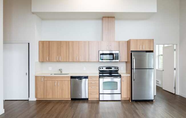 a kitchen with wooden cabinets and stainless steel appliances