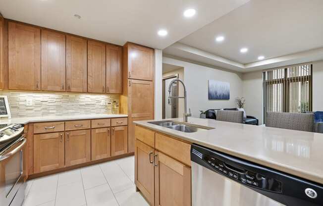 a kitchen with wooden cabinets and a white counter top