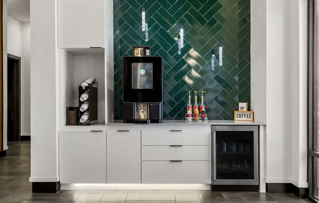 A coffee machine is on a counter with a sign that says coffee.