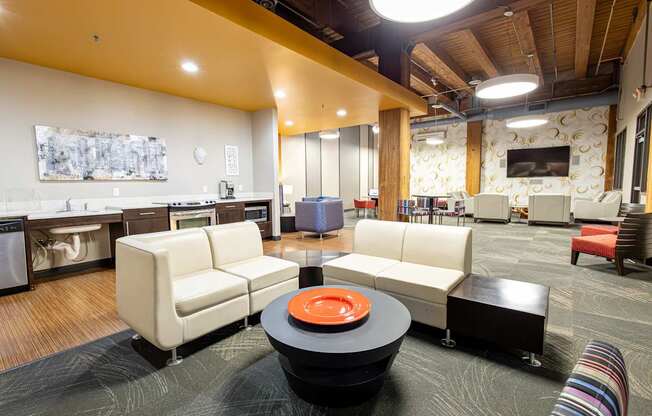 a living room with couches and chairs and a table at Lowertown Commons Apartments, Minnesota, 55101