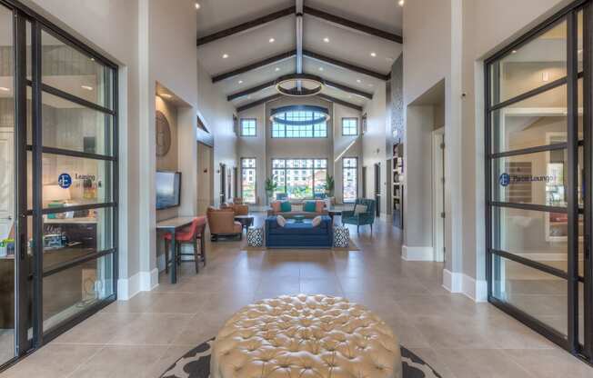 clubhouse with couch and chaise in middle and glass doors